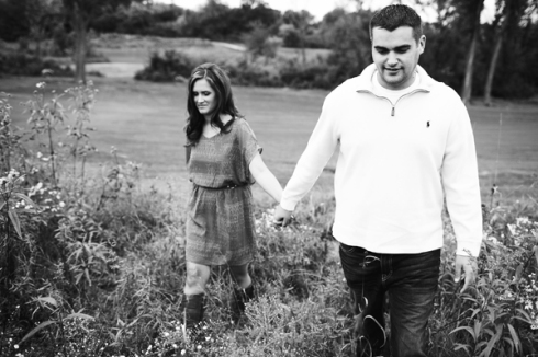 stylish couple holding hands walking oudoor engagement photo session
